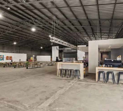 Superordinary cafe area with bar stool seating and espresso machine visible.