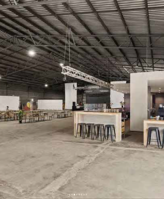 Superordinary cafe area with bar stool seating and espresso machine visible.