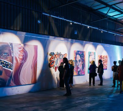 Superordinary gallery showing vibrant art in an industrial setting.