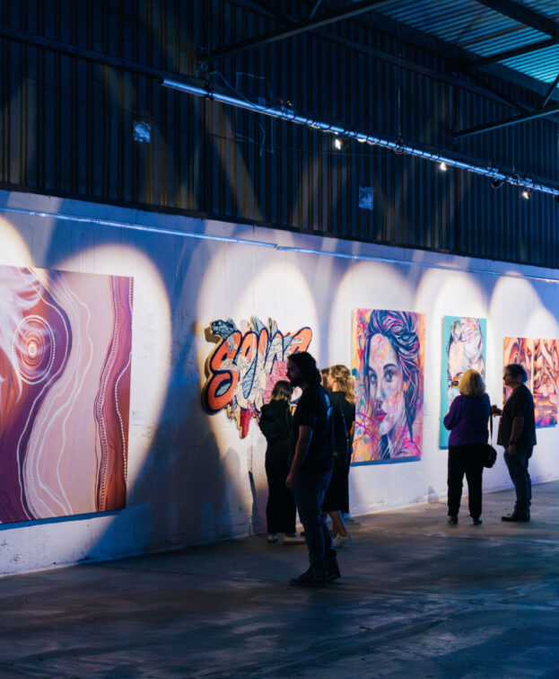 Superordinary gallery showing vibrant art in an industrial setting.